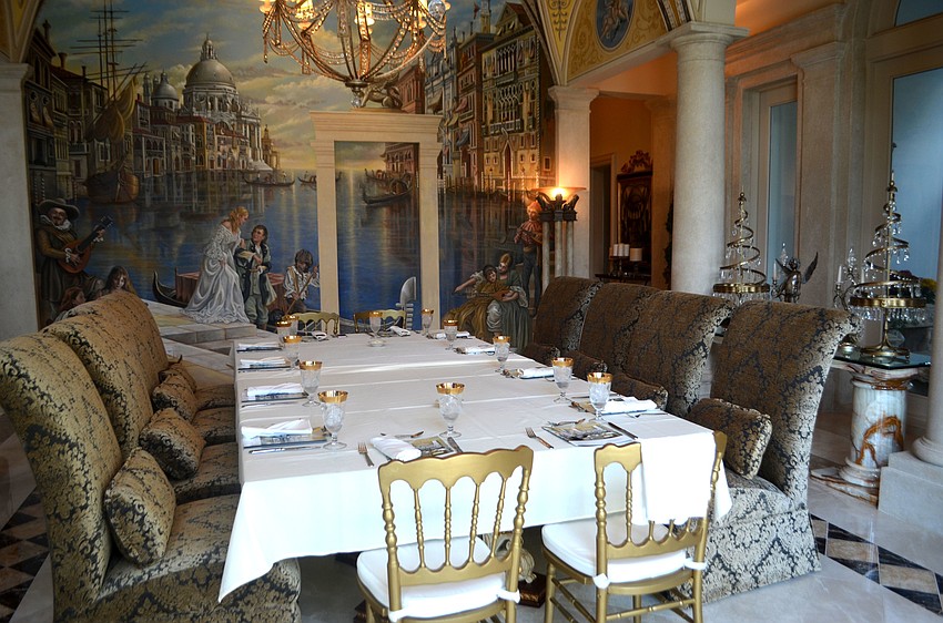 The dining room features a Venetian mural on one wall.