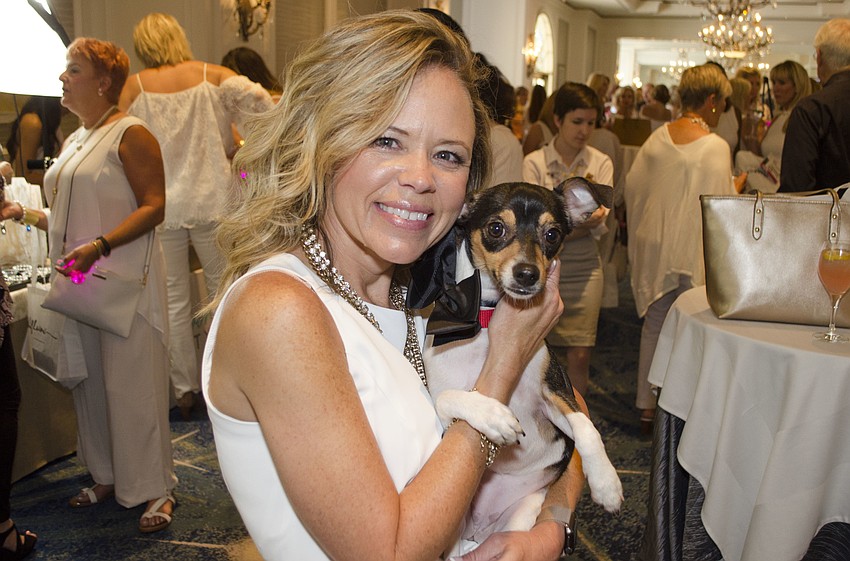 Kara Donley holds Ciara, a 7-month-old terrier mix available for adoption, at Paws on the Catwalk on April 20 at The Ritz-Carlton, Sarasota.
