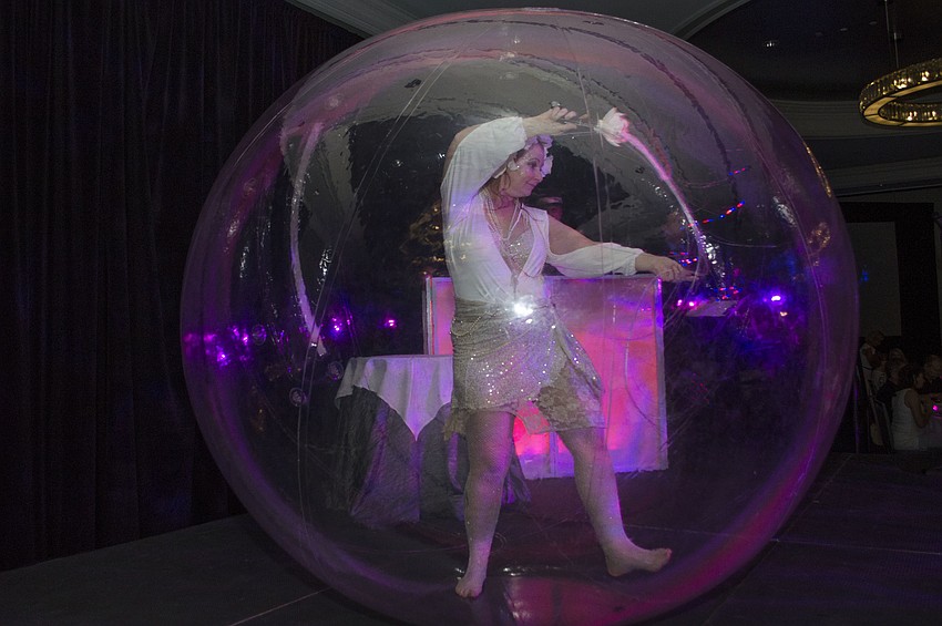 A Catalyst Fire Circus member performs before lunch at Paws on the Catwalk on April 20 at The Ritz-Carlton, Sarasota.