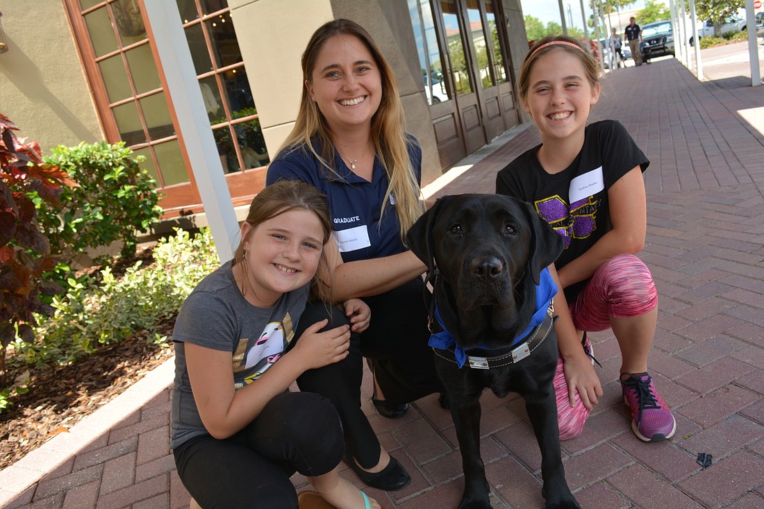 Rachel Weeks, pictured with her daughters, Hailey, left, and Audrey, right, is eager to better navigate her community with her guide dog, Plum.
