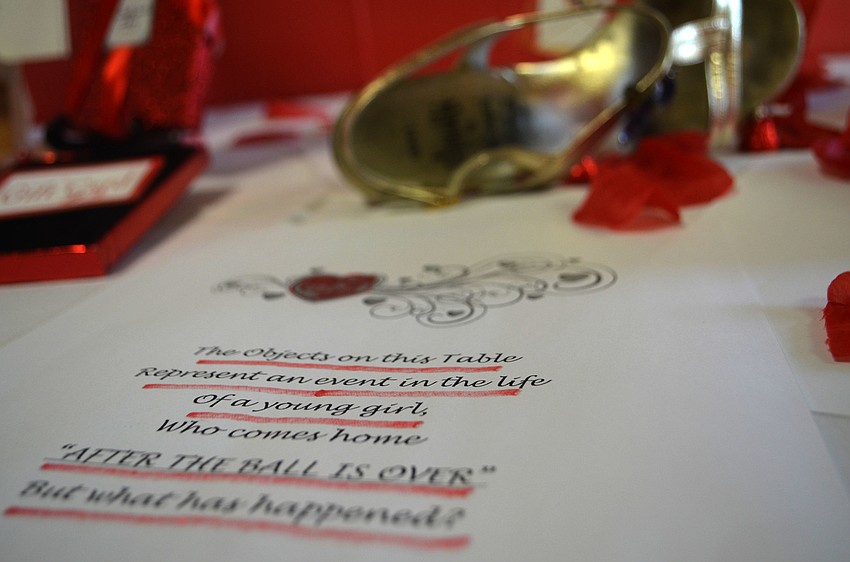 An interactive art display allowed residents to guess as to what happened “After the Ball is Over.” A high heel, a torn picture and other items were placed on the table to give clues.