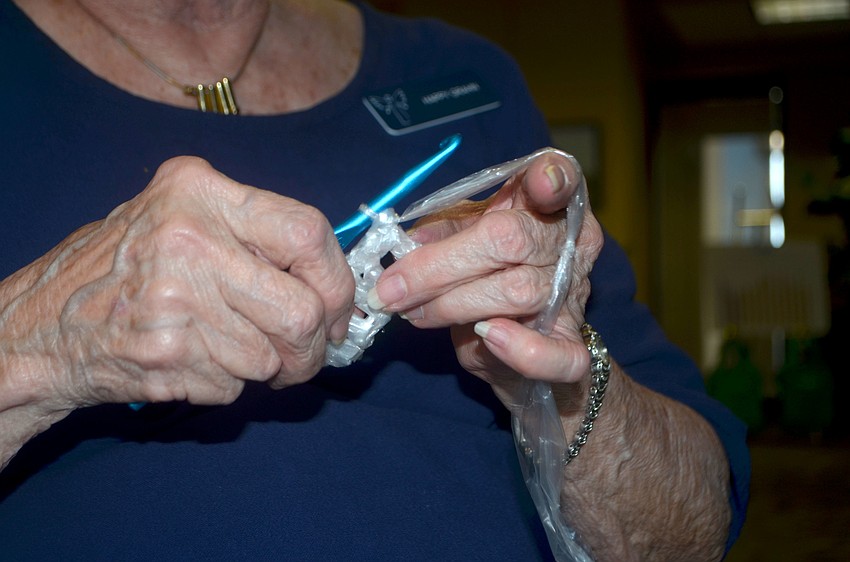 Happy Grahn made various items out of old plastic newspaper bags during the event, including a door mat.