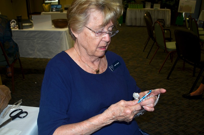 Happy Grahn made various items out of old plastic newspaper bags during the event, including a door mat.