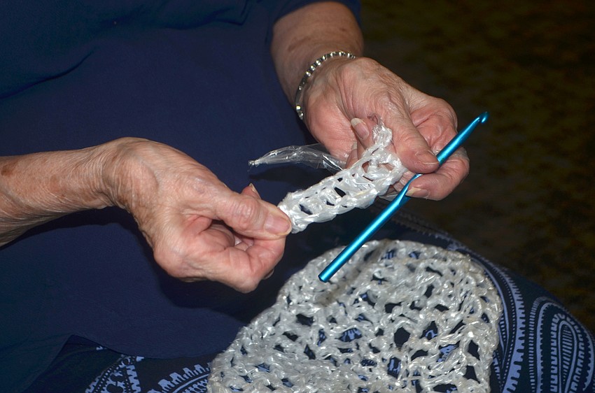 Happy Grahn made various items out of old plastic newspaper bags during the event, including a door mat.