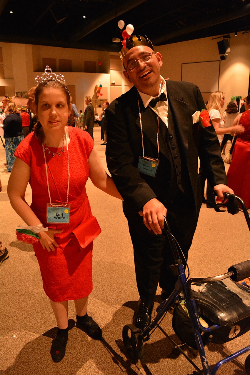 Lori Wolfe is escorted by Jamison Hernad