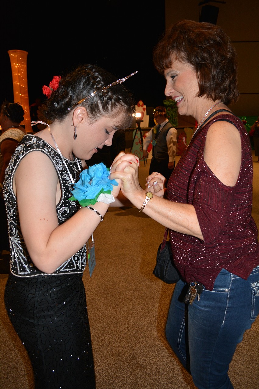 Sarah Marken dances with her mom, Sammy Marken.