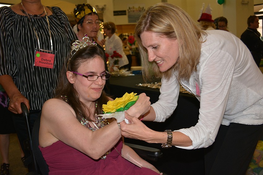 Jennifer Maurer receives her corsage from Jessica Tolson.