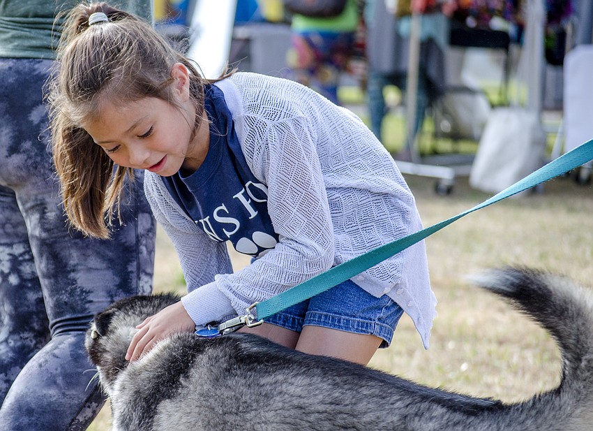 Alaina Robertson pets Tala the dog