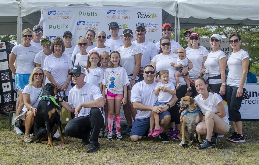 The group from Norton Hammersley Lopez and Skokos P.A. poses before the walk-a-thon