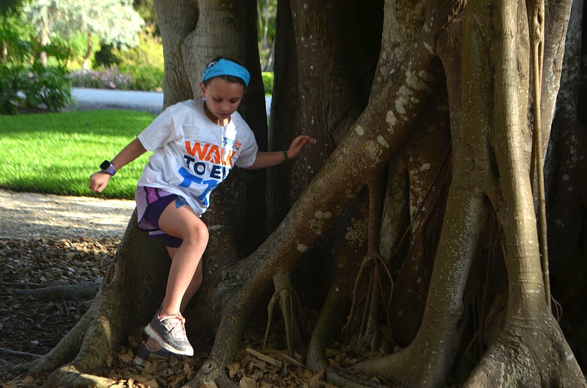 Olive Imerman hops around a tree at Joan Durante Park before the JDRF walk.
