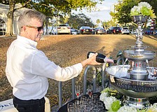 Andrew Doole adds champagne to the champagne fountain at the Suncoast Boat Show 2017 VIP Yacht Hop on April 21 at Marina Jack.