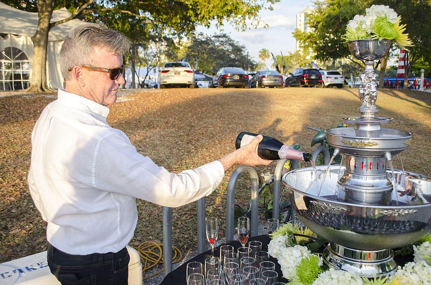 Andrew Doole adds champagne to the champagne fountain at the Suncoast Boat Show 2017 VIP Yacht Hop on April 21 at Marina Jack.