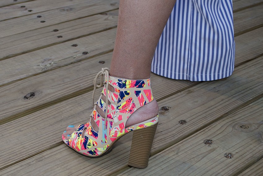 Gretchen Bauer shows off her colorful heels from A’GACI at the Suncoast Boat Show 2017 VIP Yacht Hop on April 21 at Marina Jack.