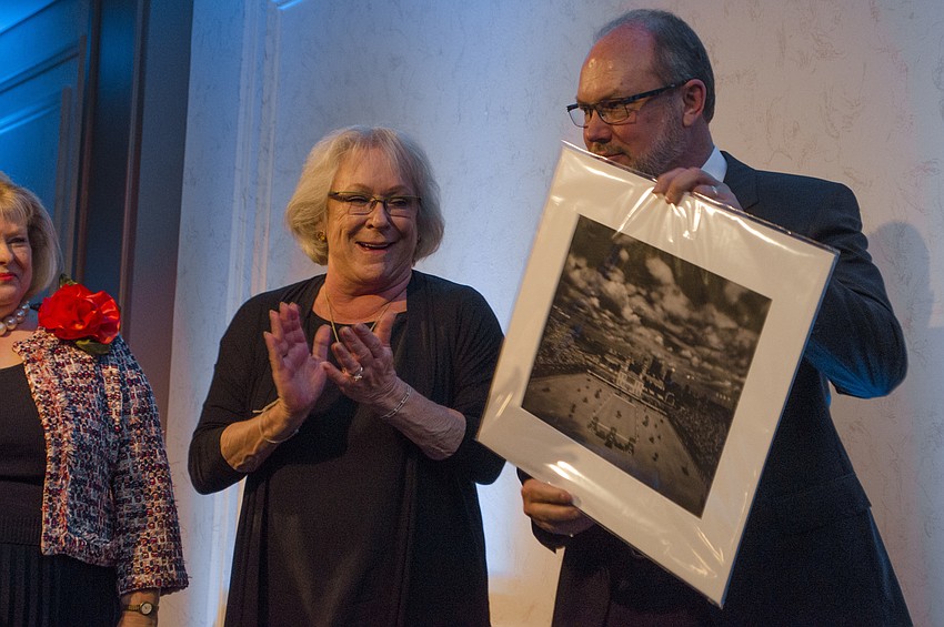 Co-Chairs Sherry and Tom Koski are awarded a print of a David Burnett photograph as a thank-you gift for planning the April 22 Greenfield Prize Dinner at Michael’s On East.