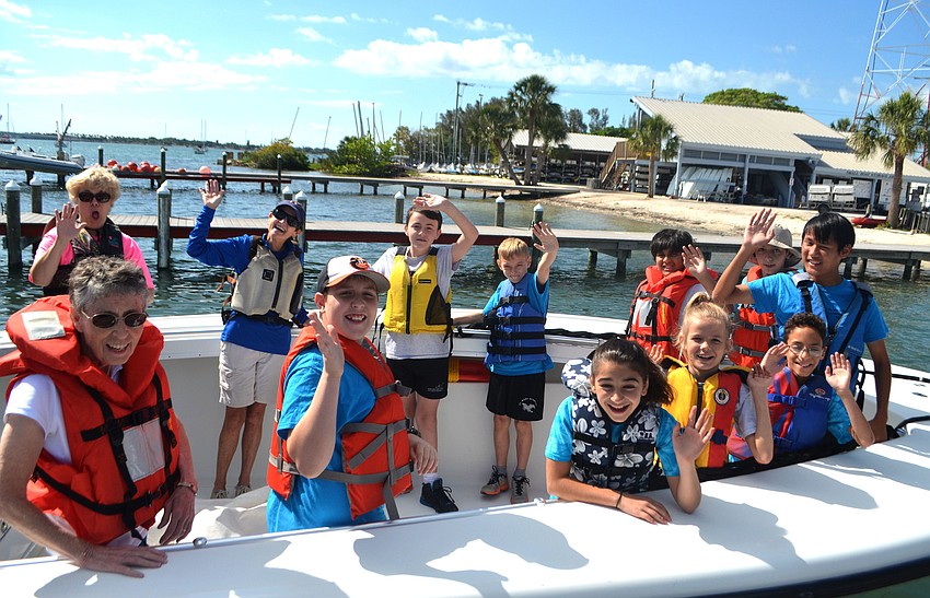 St. Mary Academy students wave as they take off on a Sarasota Police Department Water Patrol boat to explore the waters of Sarasota Bay.