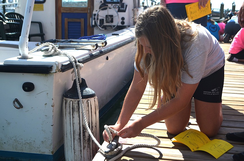 Carrie Detar ties a knot one of the Sarasota Sailing Squadron docks.