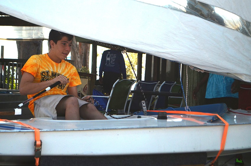 Eighth grader Ethan Washer tests out the Sunfish simulator.