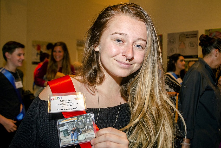 Shelby Adelman shows off the replica of her piece.