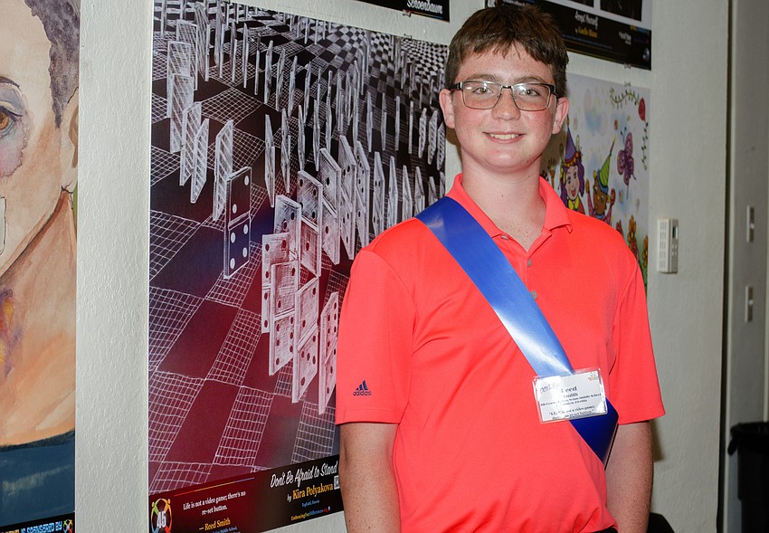 R. Dan Nolan Middle School seventh-grader Reed Smith poses next to his quote.