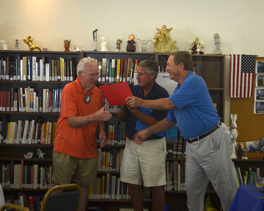 Rotary Club President Jack Rozance gives John Brill and Andy Sawyer President Certificates for their dedication to community service.