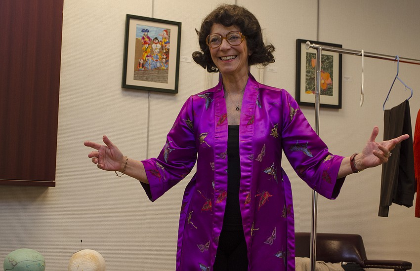 Carolyn Michel shows off her Ann Landers costume before beginning the first monologue of her Salon Series lecture on April 27 at Designing Women Boutique.