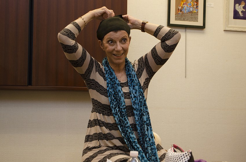 Speaker Carolyn Michel teaches eventgoers how to wear a stage wig during her Salon Series lecture on April 27 at Designing Women Boutique.