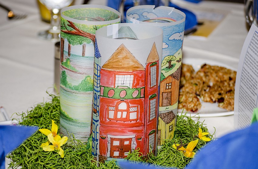 Children colored pictures, which were printed onto wax paper and positioned together to serve as the event'    s centerpieces.