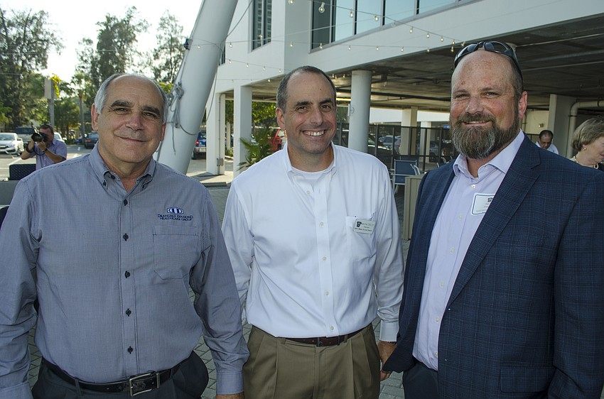 Josh Yoder, Sarasota Memorial Healthcare Foundation President Mason Ayres and David Fouche