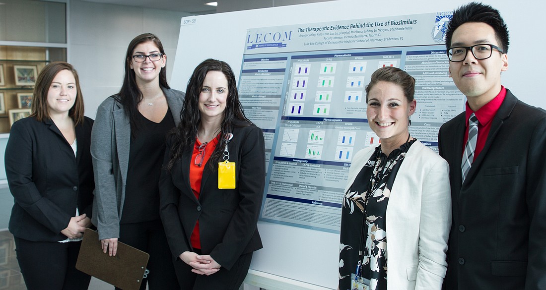 LECOM School of Pharmacy students, from left, Brandi Conely, Kelly Fero, Stephanie Wills and Johnny Le Nguyen (far right), stand with faculty mentor Victoria Reinhartz in front of the groupâ€™s winning poster presentation. Courtesy.