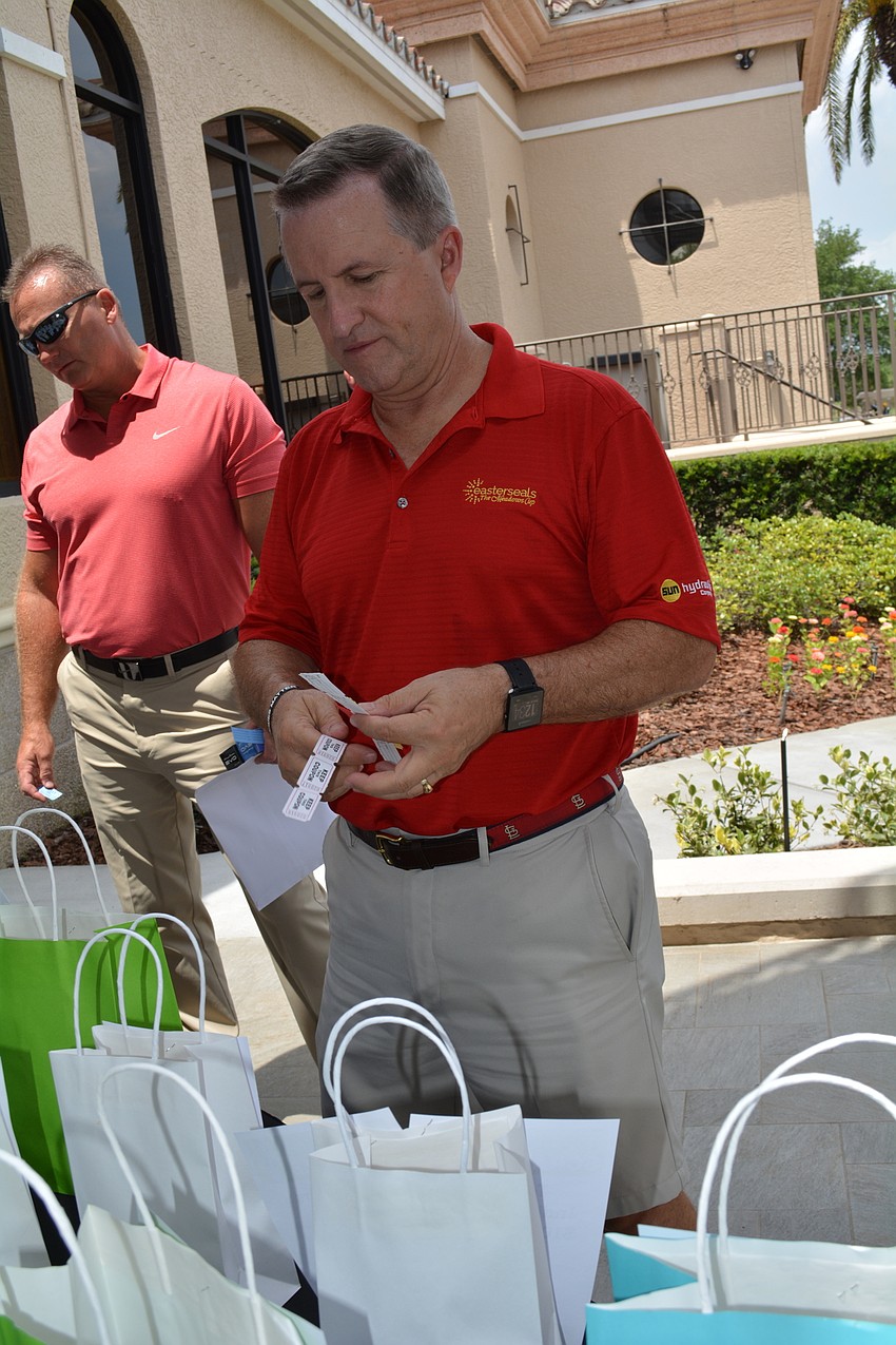 Ron Beck, of Synovus Bank, tries for silent auction items.