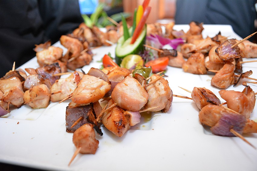 Pre-dinner appetizers include chicken skewers.