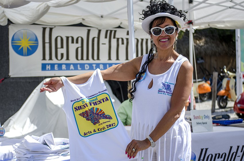 Esther Quiles  shows off a Siesta Fiesta tank top for sale at the event.