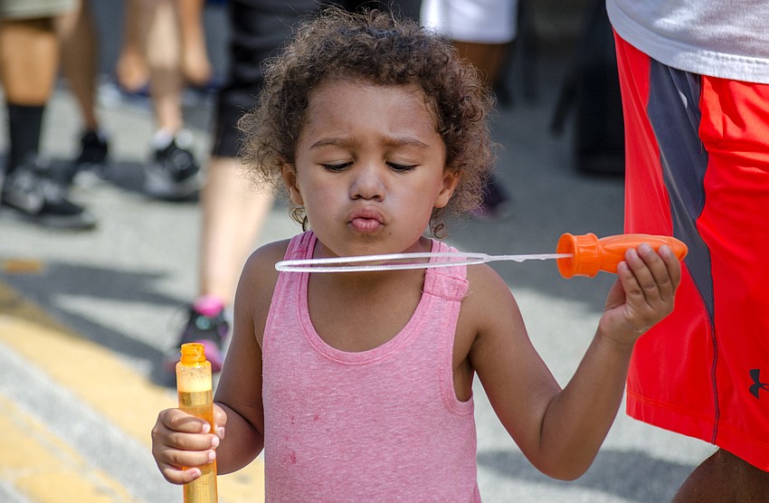 Gianna Guglielmi blows bubbles at the Siesta Fiesta