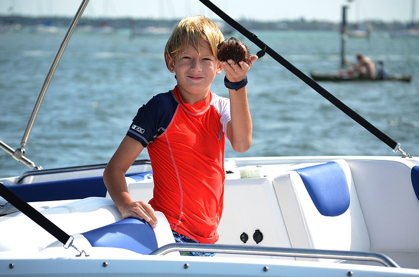 Samuel Long, 9, shows off the sea urchin he found before releasing it back in the water.