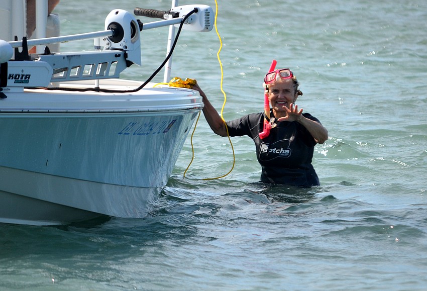 Tommy Vaughan-Birch waves before getting back in a boat at the third annual Seagrass Survey.