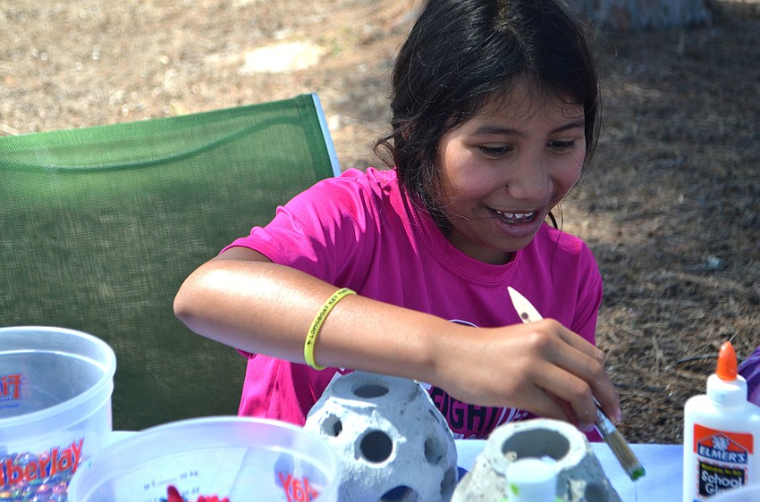 Maddie Walsh, 9, paints a coral reef replica at the Seagrass Survey on April 29.