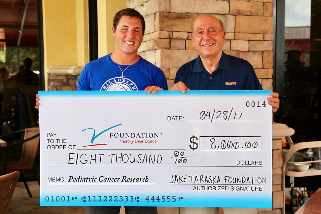 Jake Taraska presents a check to Dick Vitale and the V Foundation for Cancer Research. Courtesy photo.