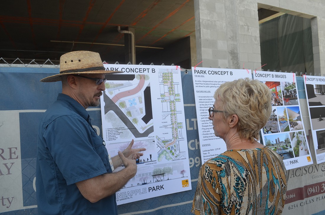 Public Works General Manager Todd Kucharski discusses the cityâ€™s two concepts for redesigning Pineapple Park at the Sarasota Farmers Market Saturday. The city is soliciting public feedback on a master plan for the downtown park.