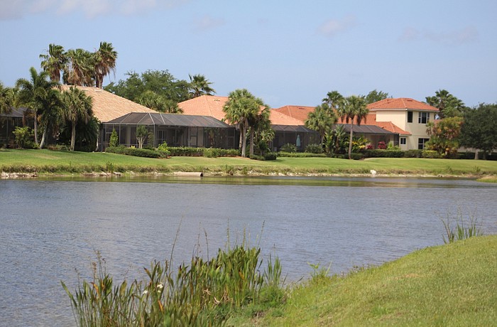 Houses sit on the lake in the GreyHawk Landing community.