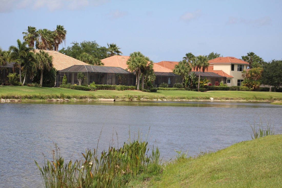 Houses sit on the lake in the GreyHawk Landing community.