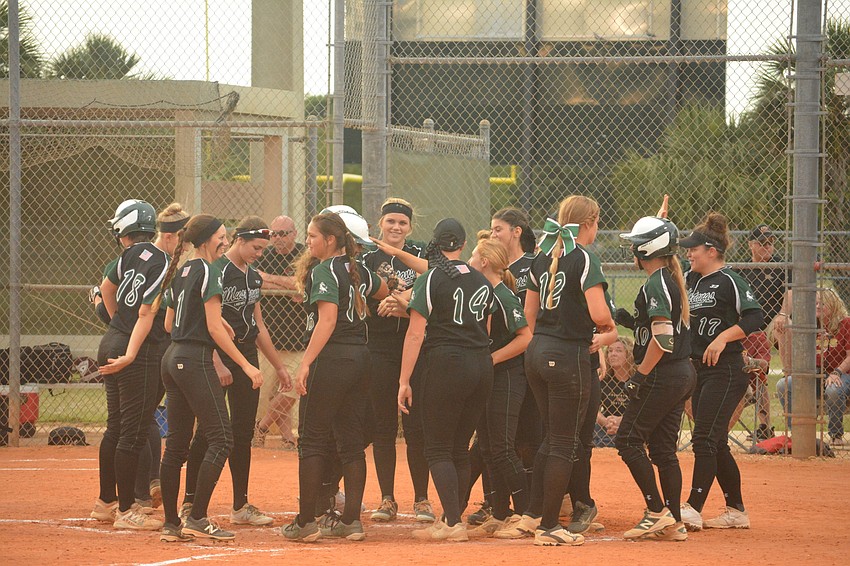 The Mustangs celebrate Morgan Cummins'    home run.
