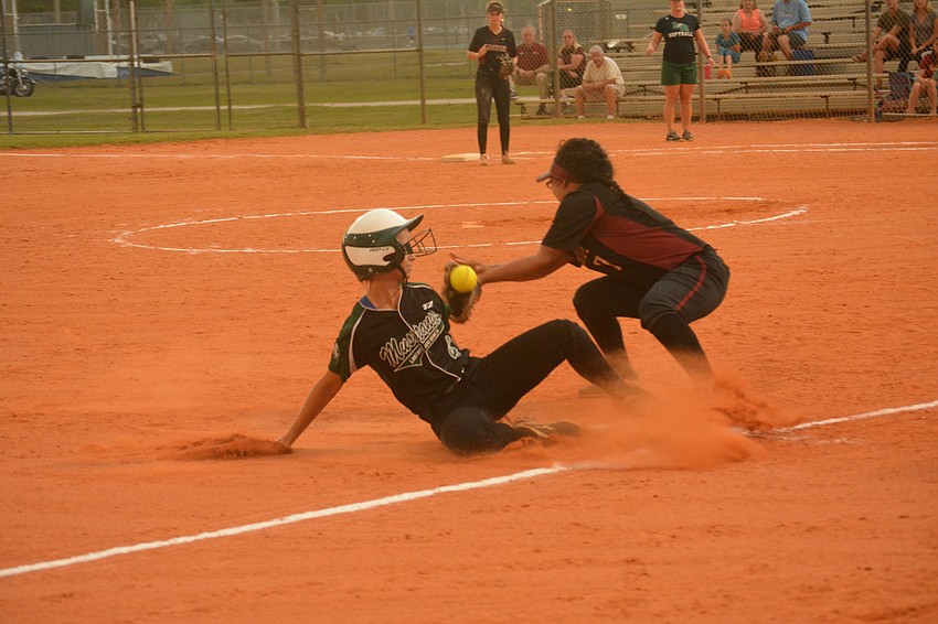 Olivia Danko slide safely into third base.