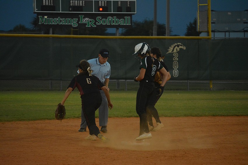 Avery Goelz kicks up dust after stealing second base.