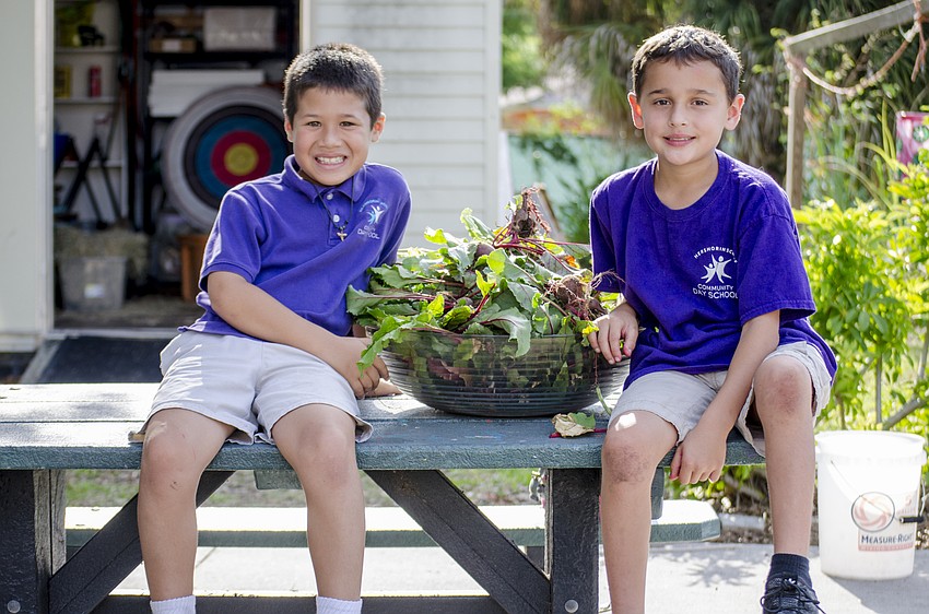 Max Lirio and Meyer Volpert pose with a bowl of recently harvested beets.