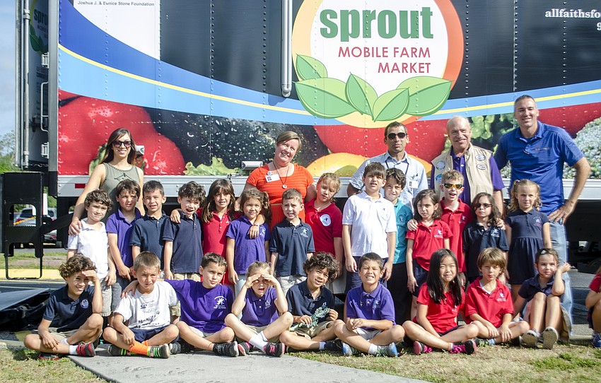 Students and faculty pose with All Faiths Food Bank staff in front of the truck outside Hershorin Schiff Community Day School.