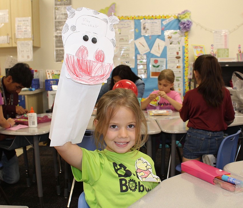 Bashaw Elementary School kindergartner Riley Cochran shows off her puppet during Winnie the Pooh and Shakespeare Too.