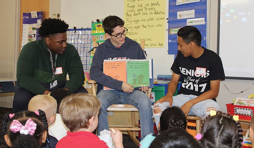 Lakewood Ranch High School seniors Devonte Grooms, Tristan Youdal and Oscar Luna read their book to the Bashaw Elementary School kindergarten class.