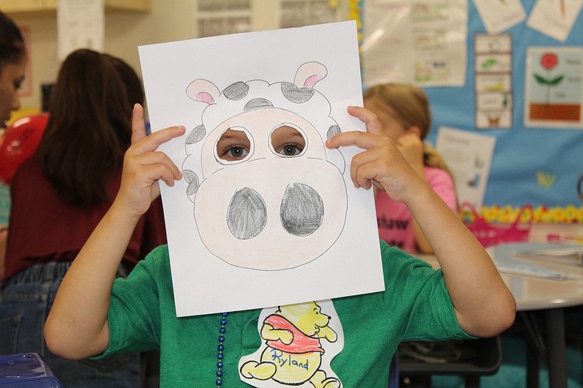 Bashaw Elementary School kindergartner Ryland Simpkins goofs off during craft time.