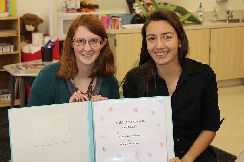 Lakewood Ranch High School seniors Stephanie Szabad and Daniela Wilhelm read the book they wrote to students at Bashaw Elementary School.