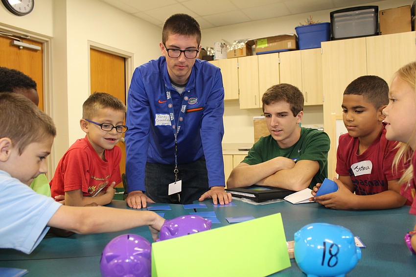 Lakewood Ranch High School seniors Randy Crutchfield and Michael Atkins play a memory game with a second grade class at Bashaw Elementary School.
